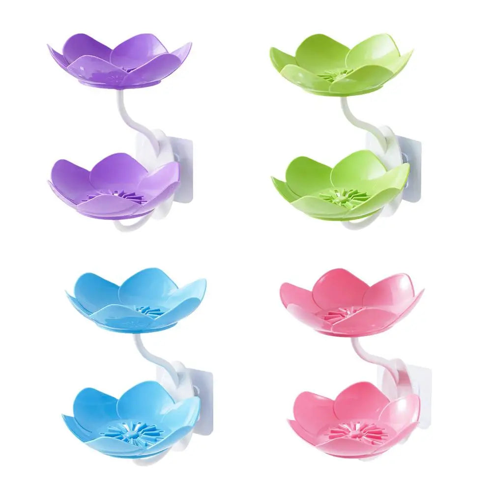 A set of three purple, green, and blue lotus-shaped bathroom storage racks with drainage features.