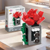A building block set depicting a retro camera and flower bonsai, featuring red, green, and gray pieces.