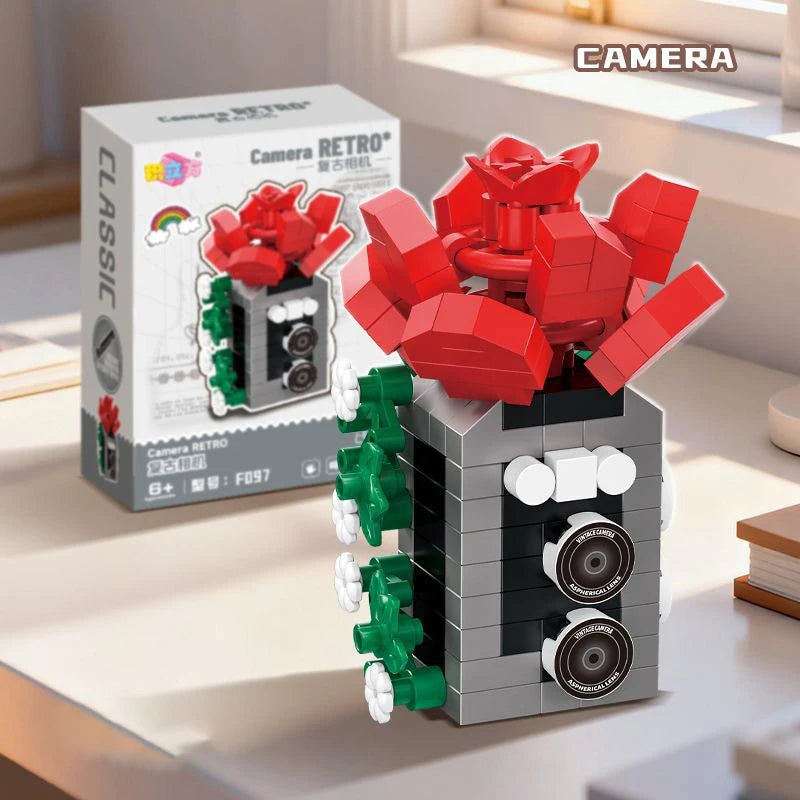 A building block set depicting a retro camera and flower bonsai, featuring red, green, and gray pieces.
