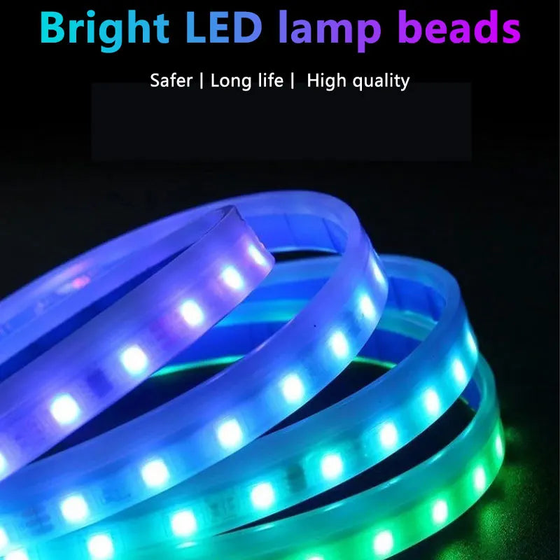 A close-up view of a flexible LED light strip with multiple colored lights, coiled in a circular shape.