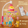 A pink musical crib mobile with various hanging toys and a remote control for sound and timing.
