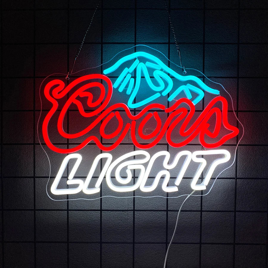 An LED neon sign shaped like a stylized animal head and the words COCOA LIGHT glowing in blue and red on a dark surface.