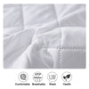 Close-up of a white fitted mattress protector showing quilted texture and features labeled as comfortable, breathable, washab
