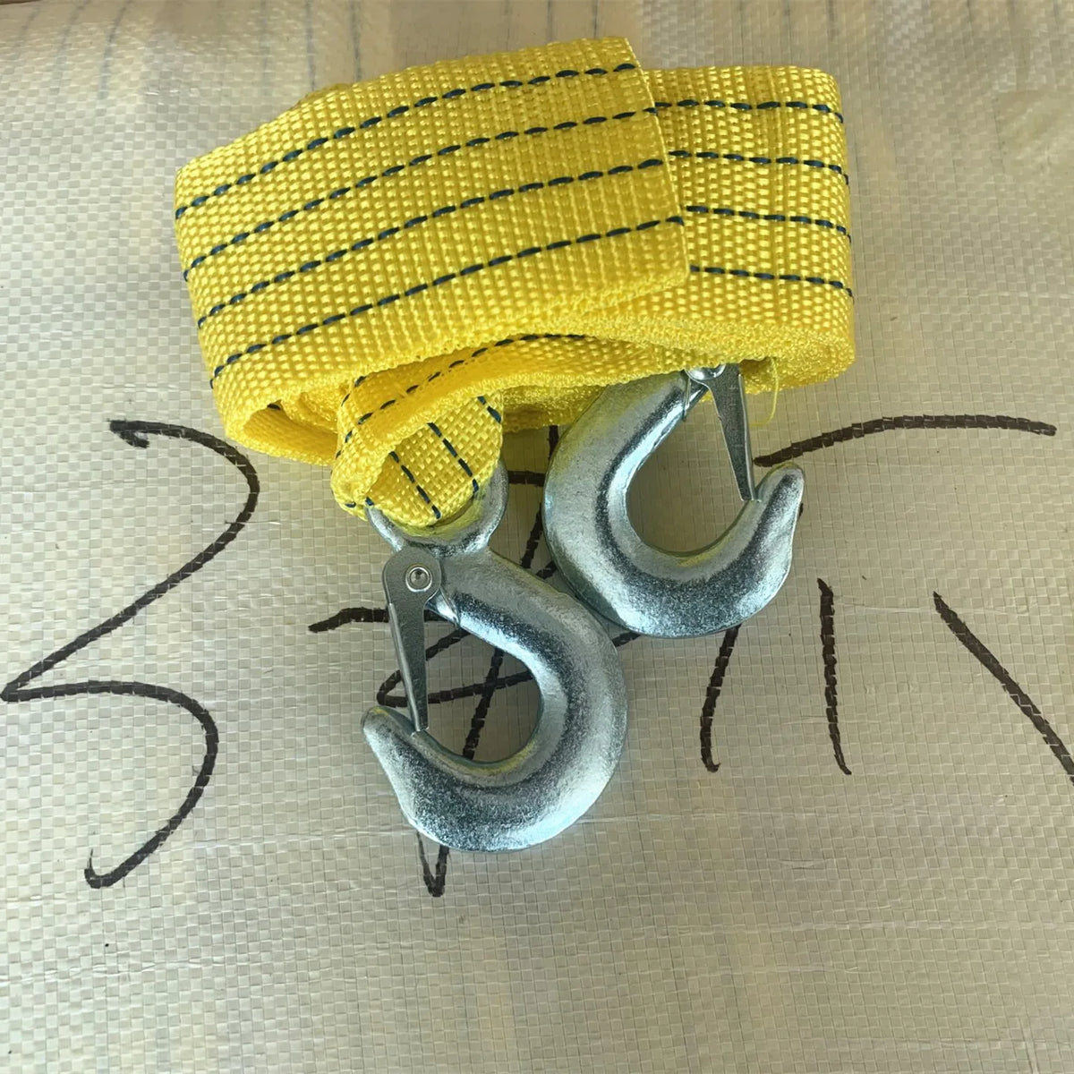 Yellow heavy-duty vehicle recovery towing strap with metal hooks