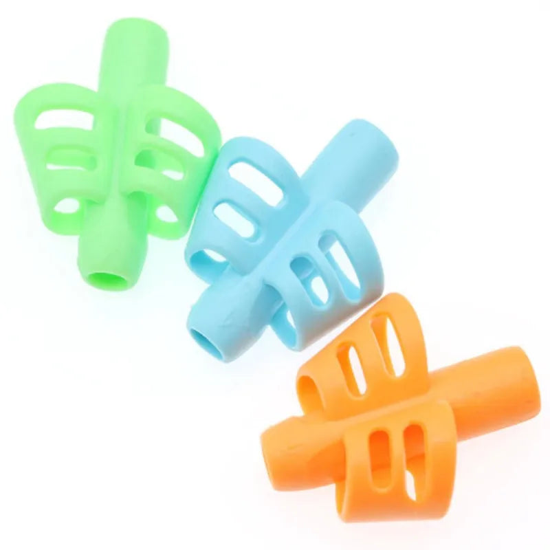 A set of three colorful ergonomic pencil grip trainers for posture correction, featuring green, light blue, and orange grips.
