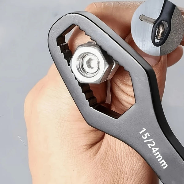 A hand holds a heavy-duty adjustable ratchet wrench with a hexagonal socket and a measuring scale.