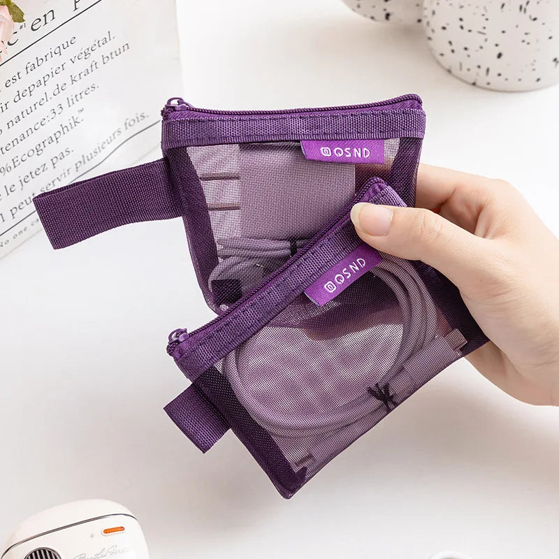 A hand holds a purple mesh storage bag with a zipper, showing transparent mesh bags for organizing small items.