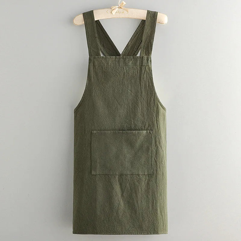 A dark olive green cotton kitchen apron hanging on a wooden hanger.