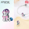 Silver unicorn pegasus charm with pink and blue crystals on a silver chain.