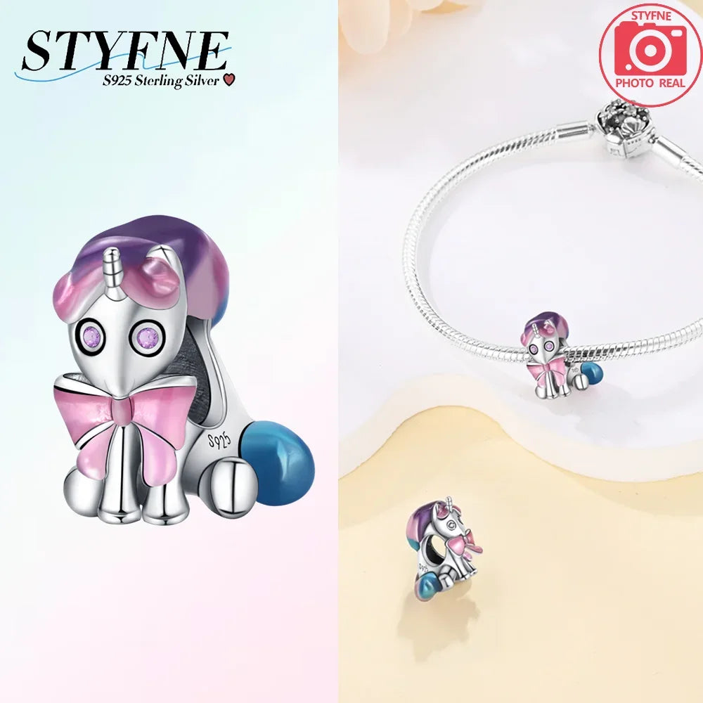 Silver unicorn pegasus charm with pink and blue crystals on a silver chain.