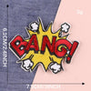 Yellow and red embroidered lettering patch shaped like an explosion with a bang text
