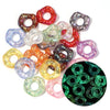 A collection of colorful acrylic spacer beads in various shades including red, green, purple, and clear, arranged on a white 
