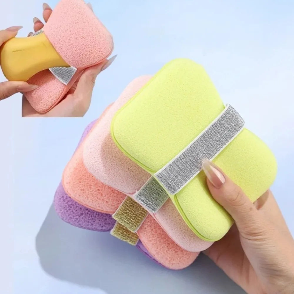 A hand holds a colorful foaming soap saver bag with a gentle exfoliating mesh, showing various pastel colors.