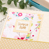 A sheet of square postage stamp paper with a pink floral design and the text Simple life on a crafting background.