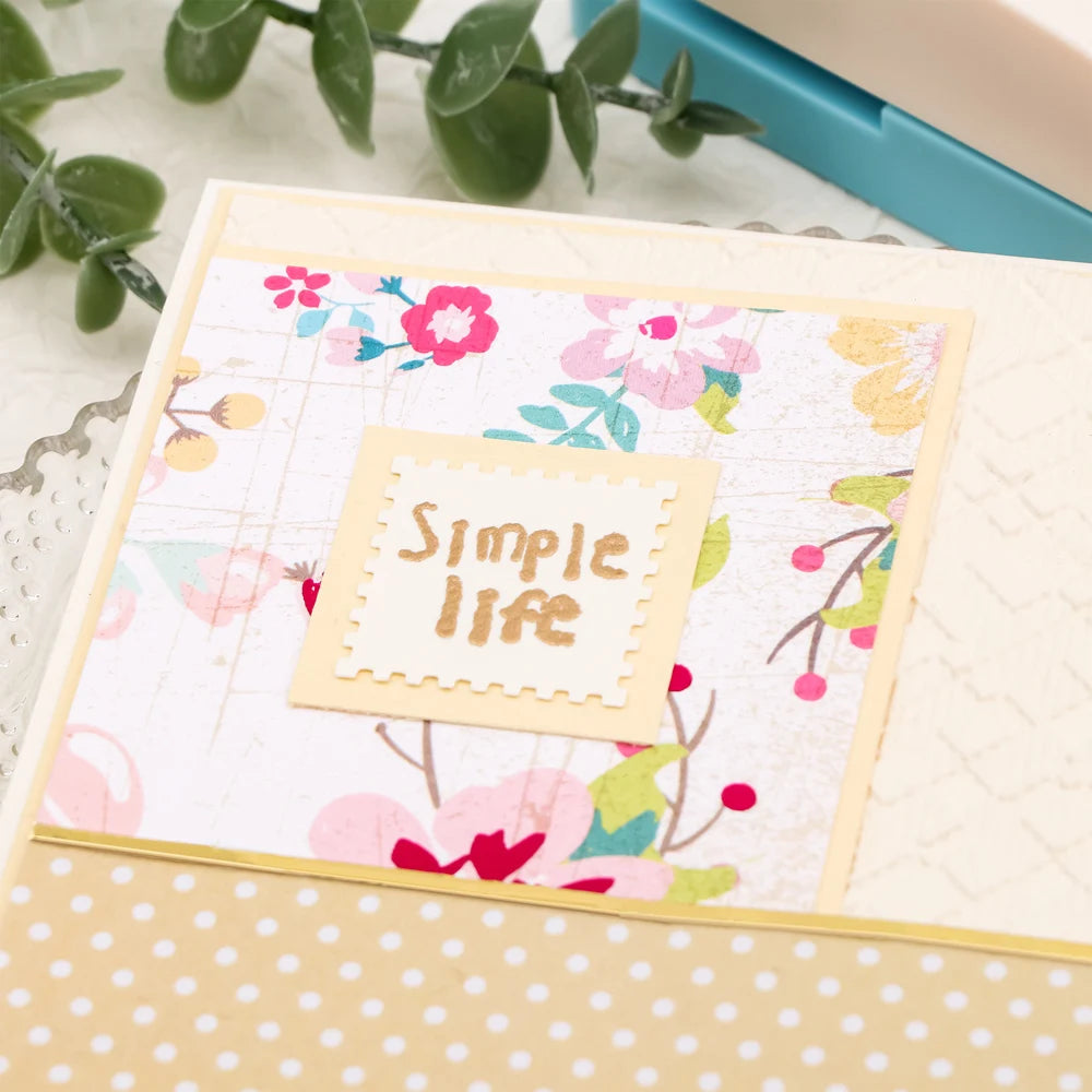 A sheet of square postage stamp paper with a pink floral design and the text Simple life on a crafting background.