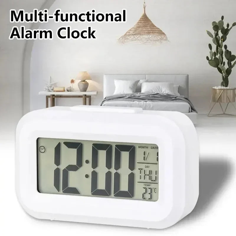 A white multi-functional alarm clock with a digital display is shown on a bedside table.