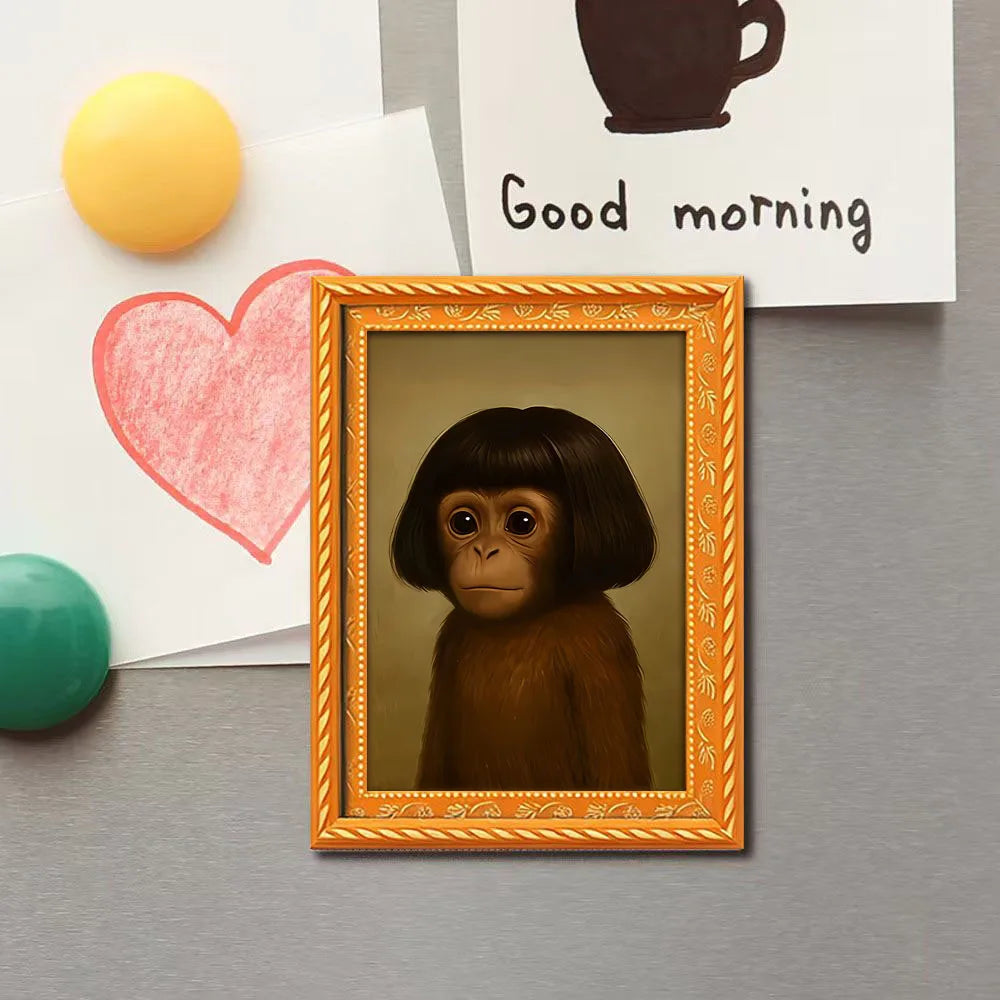 A framed picture of a monkey's face in a gold frame, placed among greeting cards and a heart.