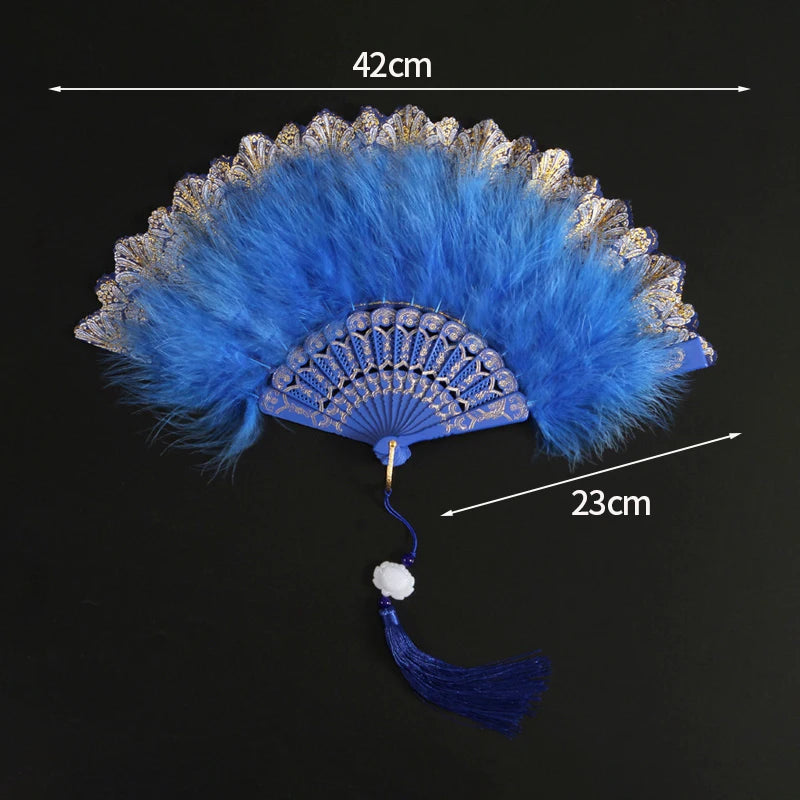 A vibrant blue lace folding hand fan with a feathered edge and a tassel, shown against a black background.
