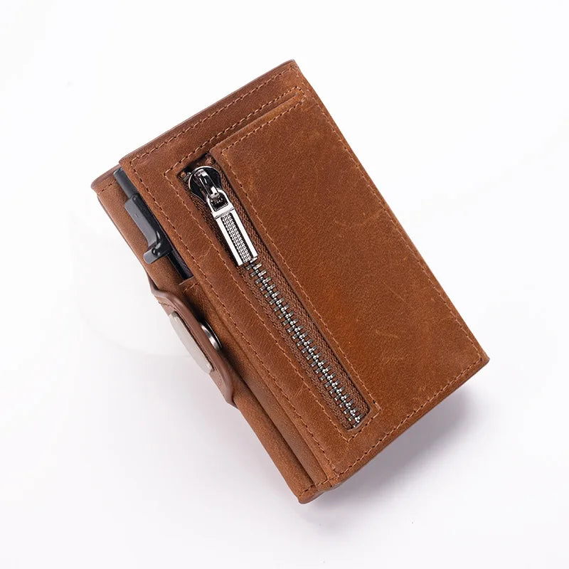 A brown leather card holder wallet with a zipper closure and pop-up feature.