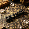 A black willow wood wishing stick rests on an antique brass zodiac chart with celestial markings and crystal stones.