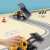A yellow die-cast construction truck toy excavator is shown sliding forward on a track.