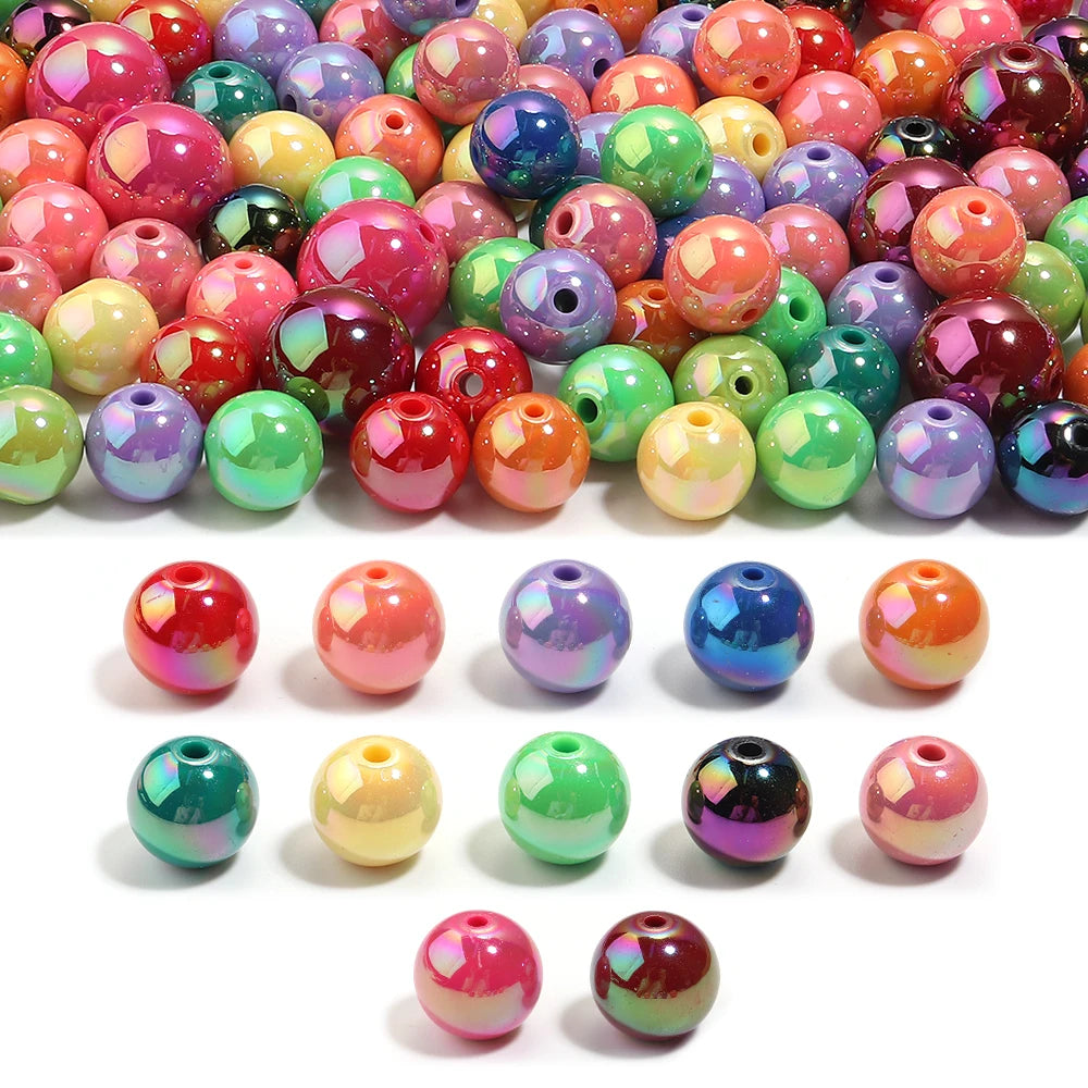 A collection of colorful acrylic round beads in various shades and finishes for jewelry making.