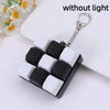A black and white mechanical keychain fidget toy with custom keycaps is shown against a white background.