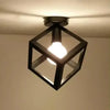 A black metal framed crystal single-head ceiling lamp hanging from the ceiling.