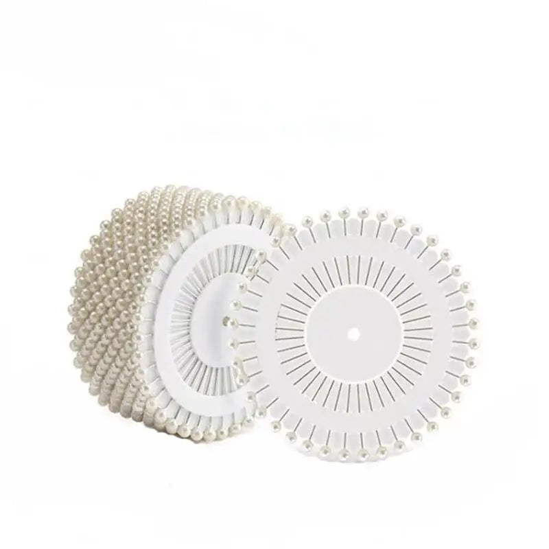 A set of colorful round pearl straight pins for sewing and crafts, shown in a flat lay.