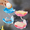 A hand is holding a white soap dispenser, which is attached to a two-tier bathroom storage rack with drainage.
