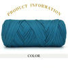 A skein of teal blue thick polyester blend yarn coiled for knitting and crochet.