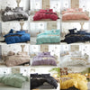 A collection of soft washed duvet covers in various shades including pink, purple, blue, and yellow with pom-pom trim.