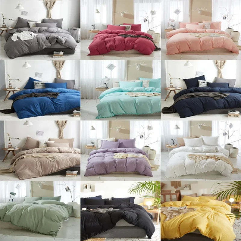 A collection of soft washed duvet covers in various shades including pink, purple, blue, and yellow with pom-pom trim.