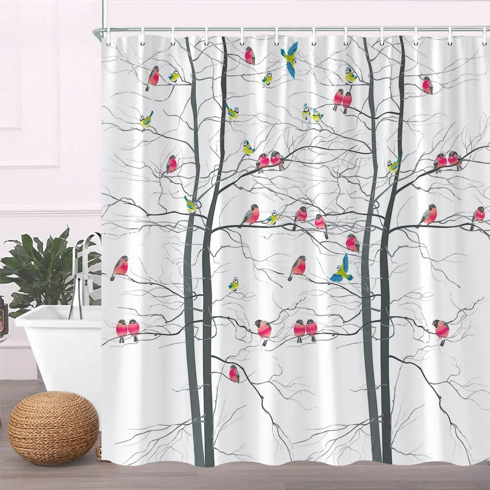 A white fabric shower curtain featuring black tree branches and colorful birds flying through them.