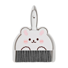A white cartoon broom and dustpan set with a cute animal face design.