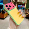 A hand holds a color blocking phone case with a pink back and yellow front, displaying the large camera window.