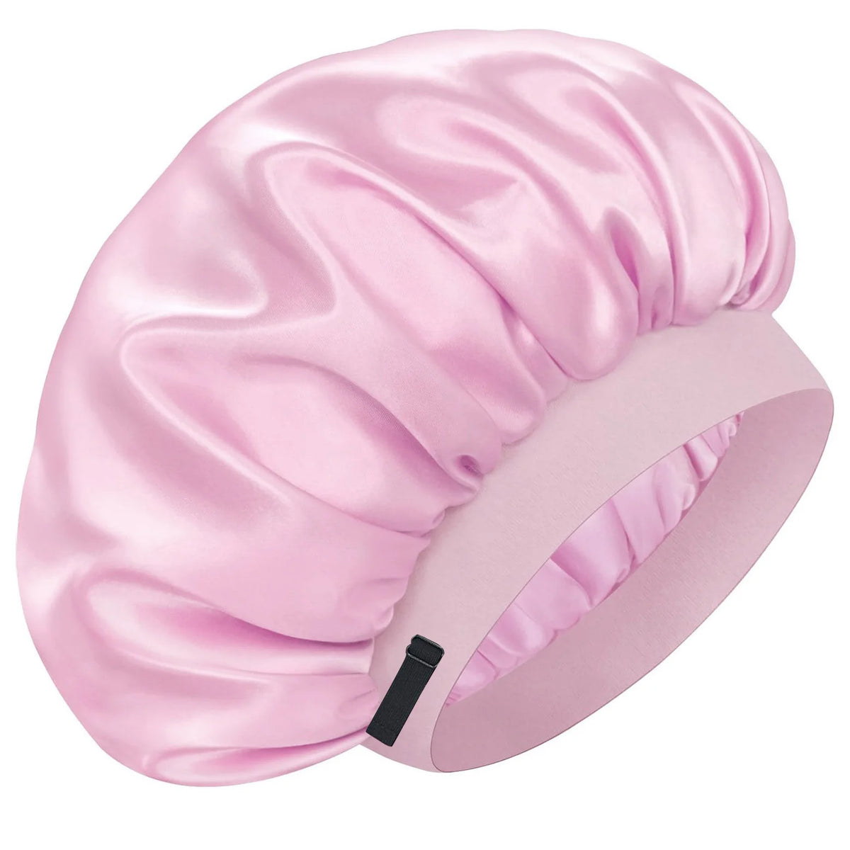 A pink silk sleep cap with gathered fabric and an adjustable band is shown from a side angle.