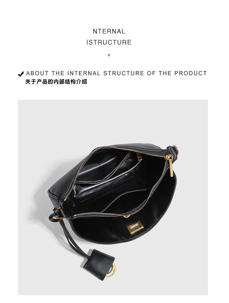 A black leather tote bag with gold-toned metal hardware shown from above.
