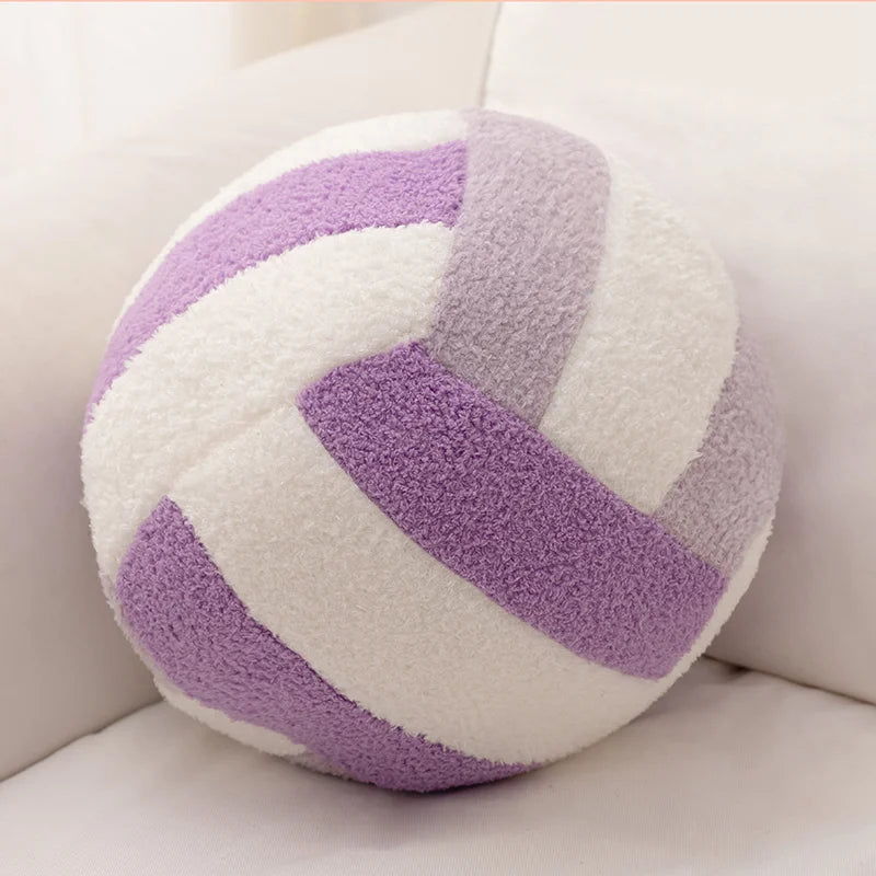 A round simulation volleyball plush toy pillow with white and purple stripes resting on a white surface.
