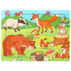 A wooden jigsaw puzzle featuring various woodland animals like a fox, bear, rabbit, and squirrel in a green field.