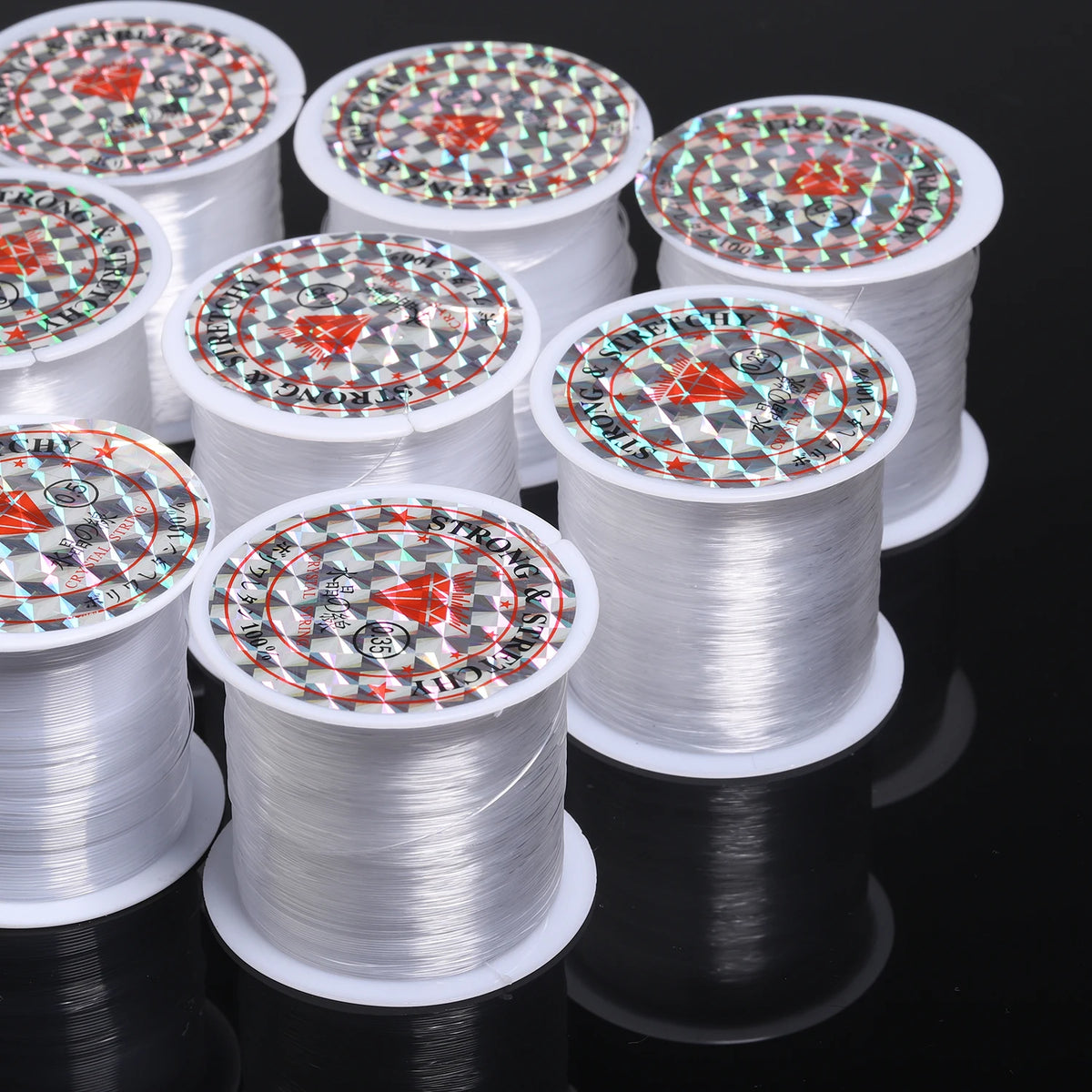 Rolls of white nylon beading cord with decorative patterns for jewelry making