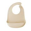 A beige silicone baby bib with a catch pocket for feeding