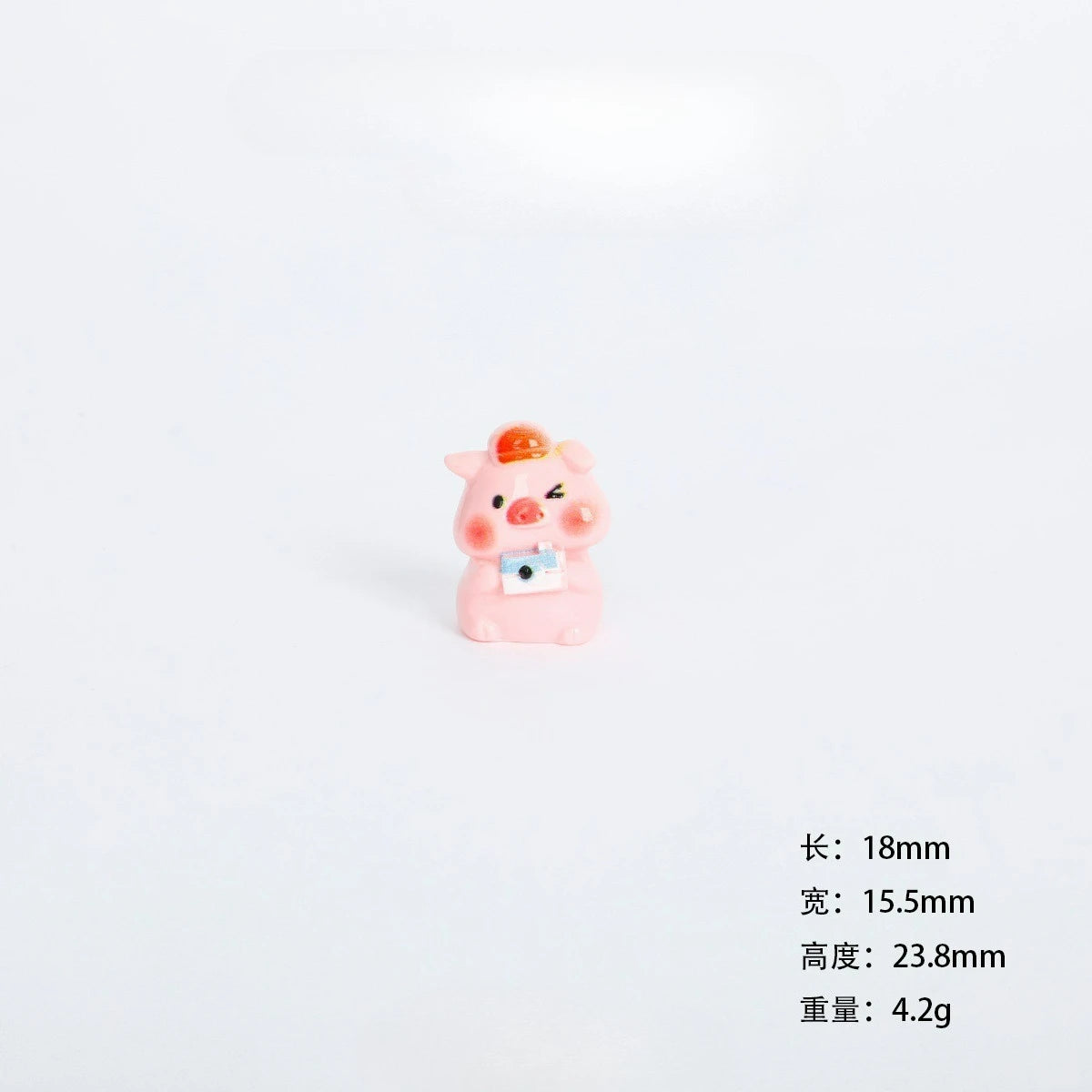 A small pink resin pig figurine with an orange snout and a blue camera accessory.