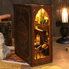 A dark wooden book nook kit featuring an arched interior with detailed miniature scenes and warm lighting.