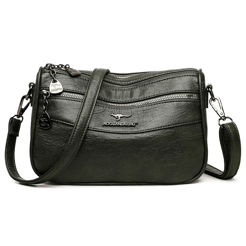 A black leather compact square crossbody bag with double-deck storage and silver hardware.