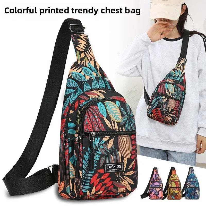 A woman wears a colorful printed trendy chest bag featuring leaf patterns and multiple pockets.