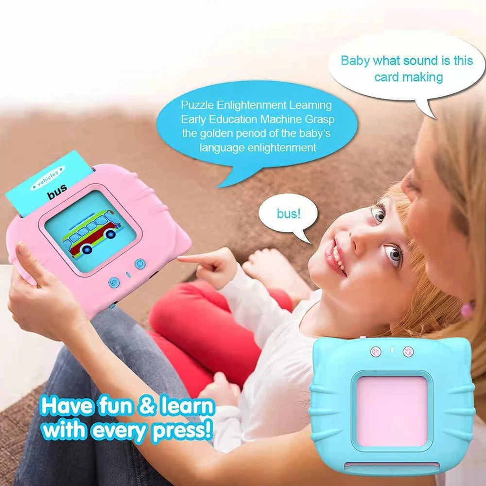 A woman is showing a pink talking flash card learning toy to a young child.