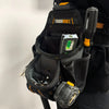 Black heavy-duty construction tool pouch with a clip and hammer loop attached to a dark garment.