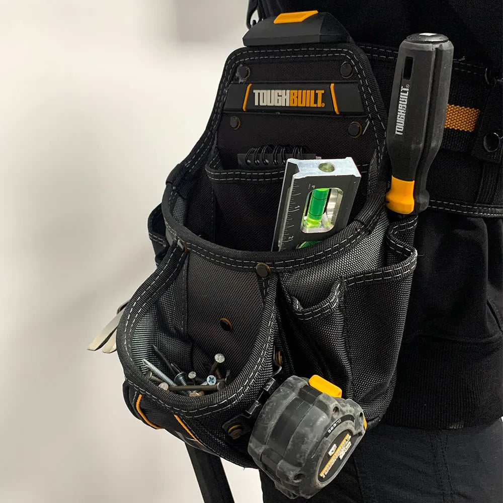 Black heavy-duty construction tool pouch with a clip and hammer loop attached to a dark garment.