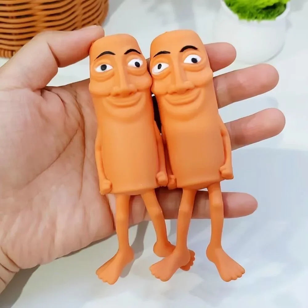 Two orange squishy fidget toys shaped like funny, elongated figures are held in a hand.